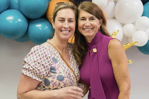 Two Women Pose Cheek to Cheek for a Photo at an Open House in Lafayette