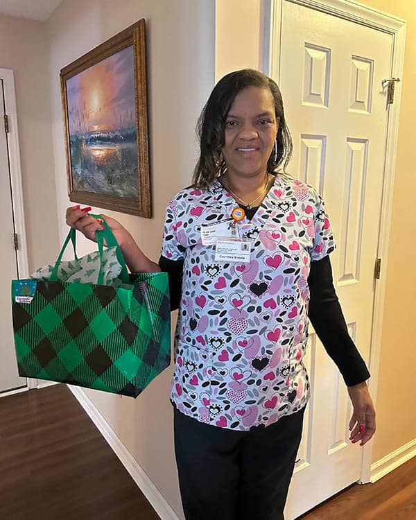 Female caregiver holding gift bag