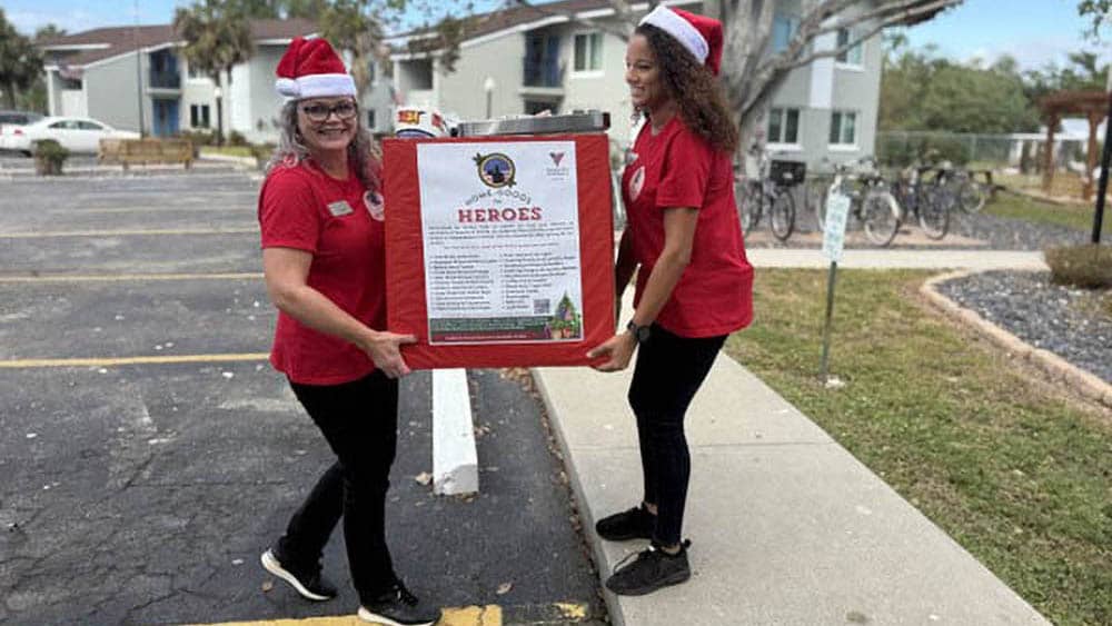 two women carrying dontations for veterans