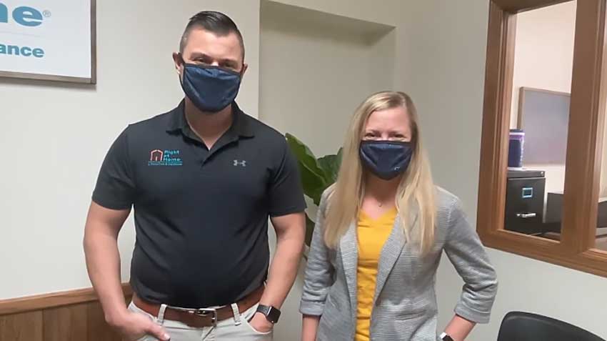 Right at Home Owners Jeremy and Kristin Starkel wearing masks in their office