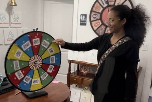 African American Female Caregiver Spinning a Prize Wheel at Right at Home Rockwall's Caregivers Week Festivities