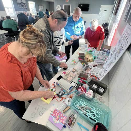 Craft Table with Volunteers Getting Supplies to Write and Send Greeting Cards