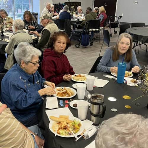 Table of Women Enjoying a Meal During the Trinity Hospice Luncheon
