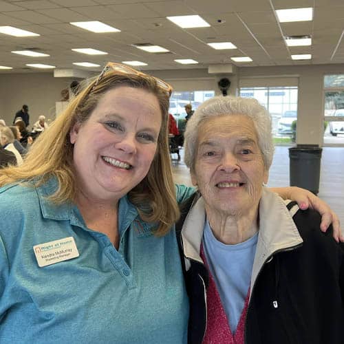 Two Women Embrace and Pose for a Photo at the Trinity Hospice Luncheon