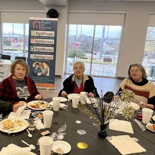 Table of Three Women Enjoying a Meal During the Trinity Hospice Luncheon