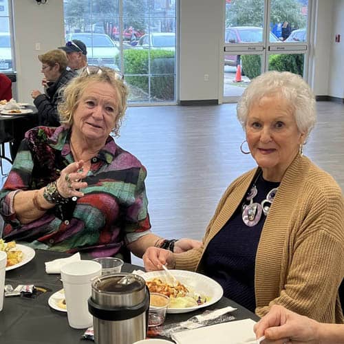 Table of Two Women Enjoying a Meal During the Trinity Hospice Luncheon