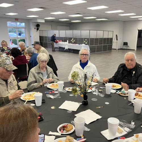 Table of Seniors Enjoying a Luncheon Meal During the Trinity Hospice Luncheon