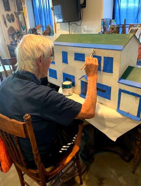 Senior painting dollhouse