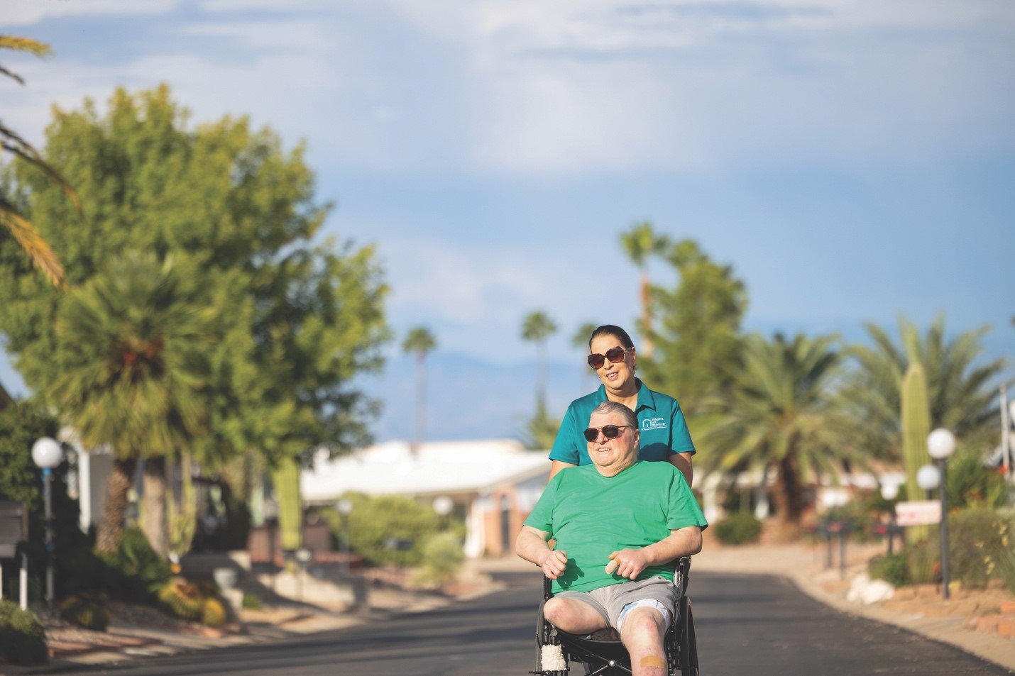 elderly-man-in-wheelchair-outside-with-caregiver