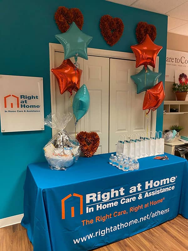 Right at Home Athens Ribbon Cutting event booth with gifts