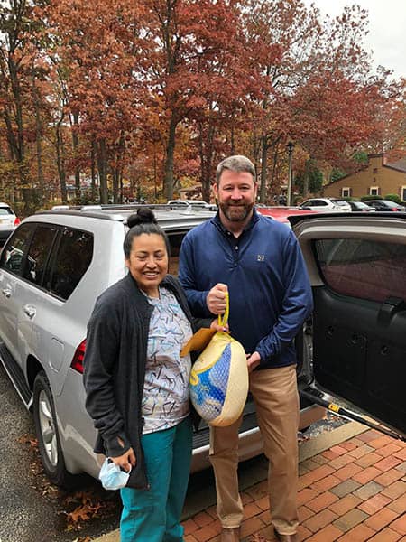 Brian Maroney with Carmen Galindo (CHHA) posing with a frozen turkey