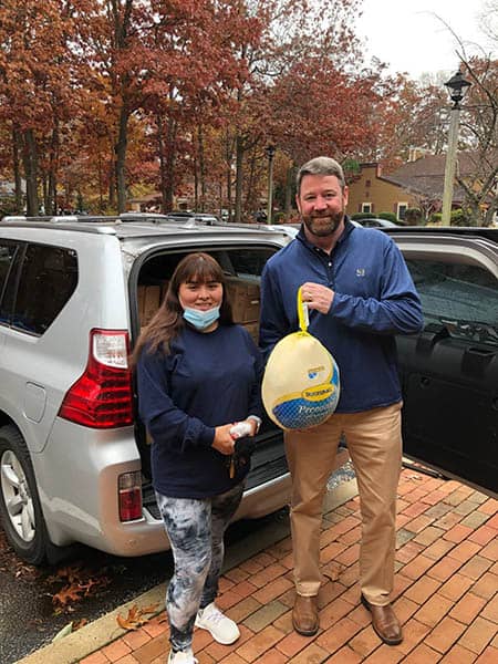 Brian Maroney with Karla Meza (CHHA) posing with a frozen turkey