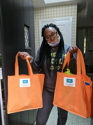 Shawnea Nelson Adems holding a Right at Home Back to school bag