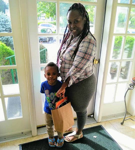 Female caregiver for Right at Home Greater Fairfield County along with her young son at the Back To School Event