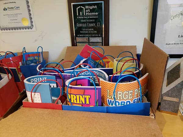 Box filled with Back to School supplies in bags for the back to school event at Right at Home of Greater Fairfield County