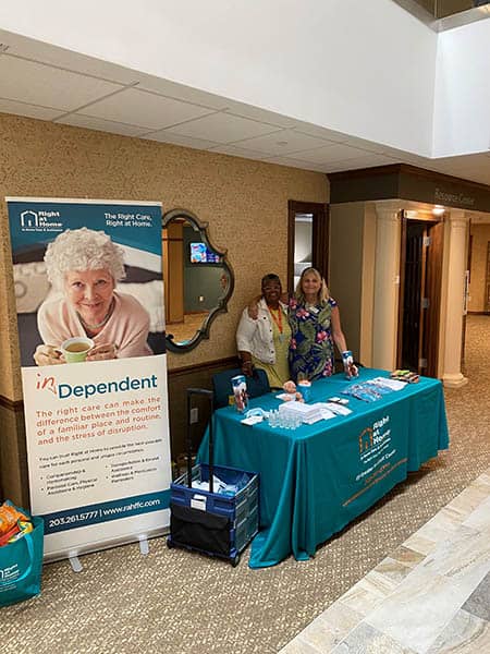 Lisa Randall, Co-owner of right at home greater fairfield county sitting with Dariann Gatison at the River Valley Health Fair 2021