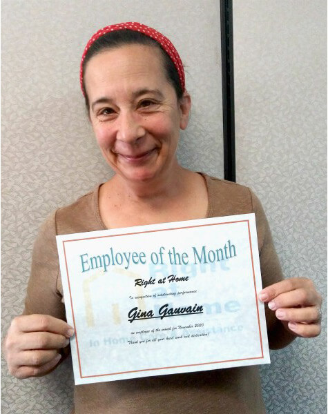 Gina G. holding Employee of the Month certificate