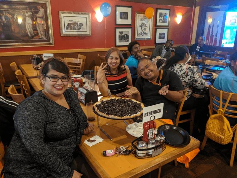 Group around table at Caregiver Appreciation Party at Shakey's in Burbank