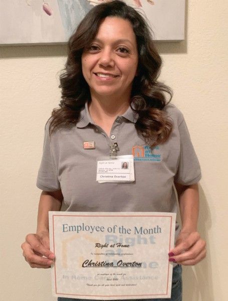 Photo of Employee of the Month Christina O. holding certificate