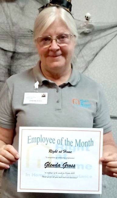 Glenda Gross holding an Employee of the Month certificate 