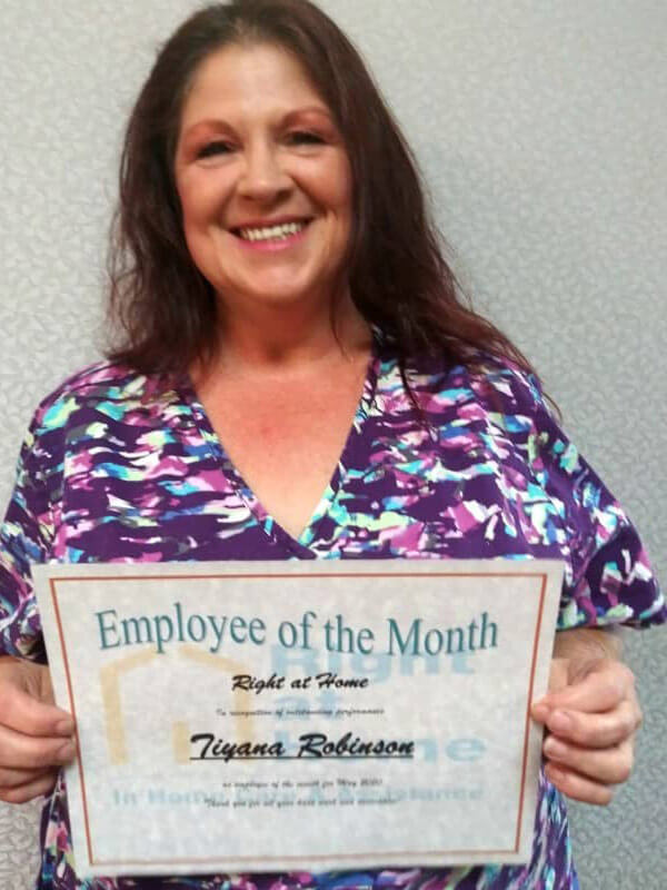 profile photo of Tiyanna holding Employee of the Month certificate