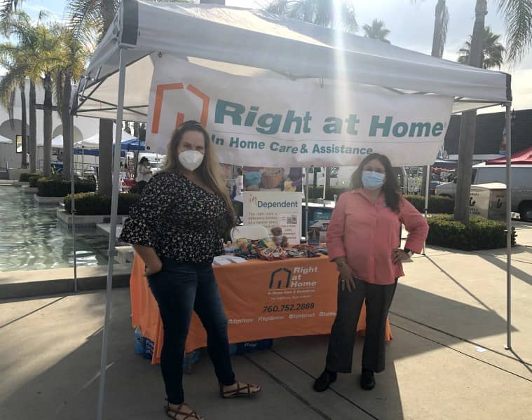 Carmen and Michelle under Right at Home tent at North County Wellness Fair