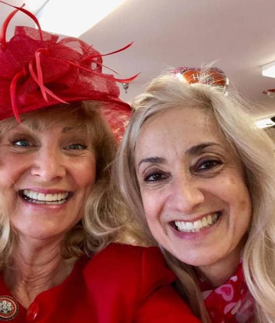 Two ladies in red hats