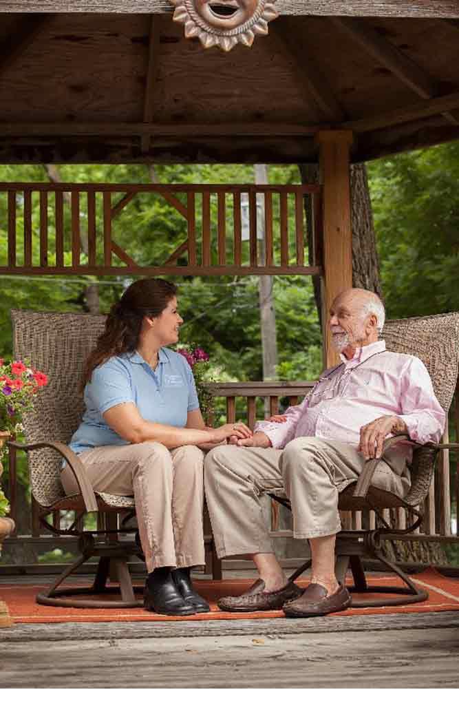 Female Caregiver with Male Client Outdoors Under a Gazebo