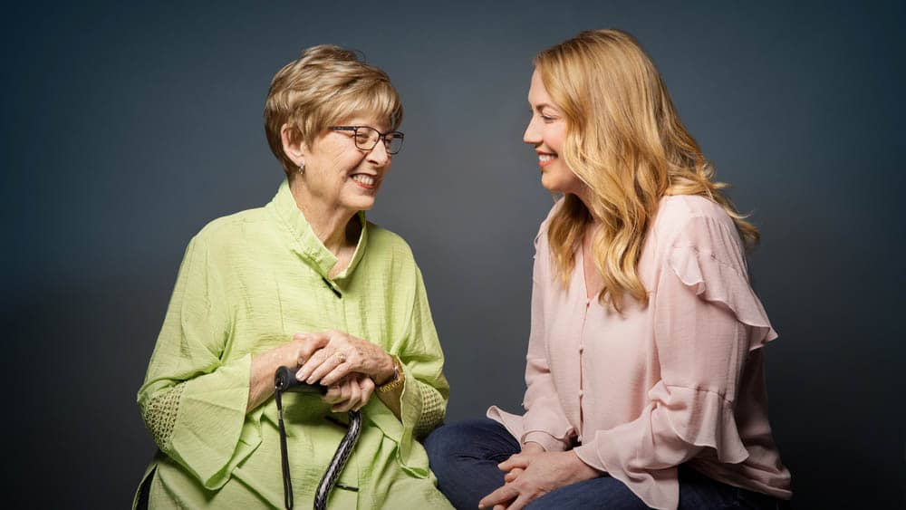 A mother and adult daughter sitting together