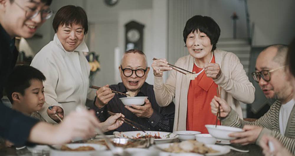 a family sitting together eating a meal