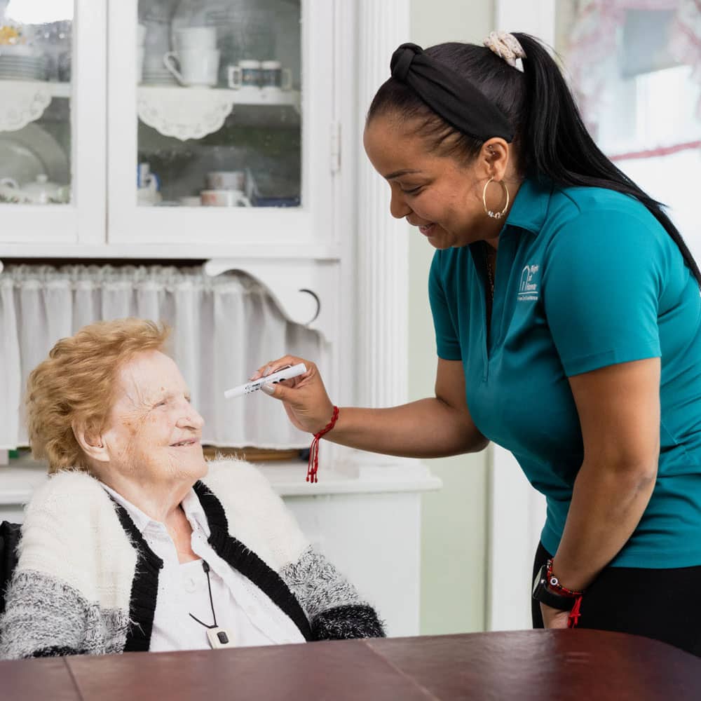 Caregiver examining a clients eyes.