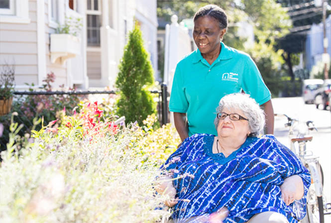 Female Caregiver Helping Client Enjoy the Outdoors in a Wheelchair