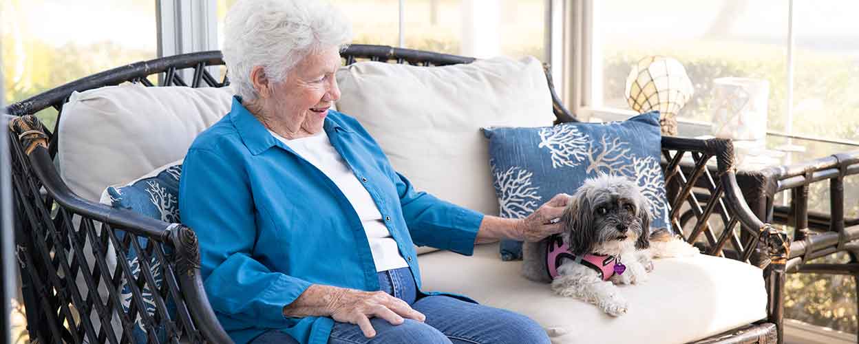 senior woman sitting with dog