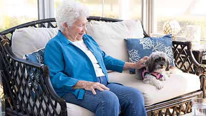 senior woman sitting with dog