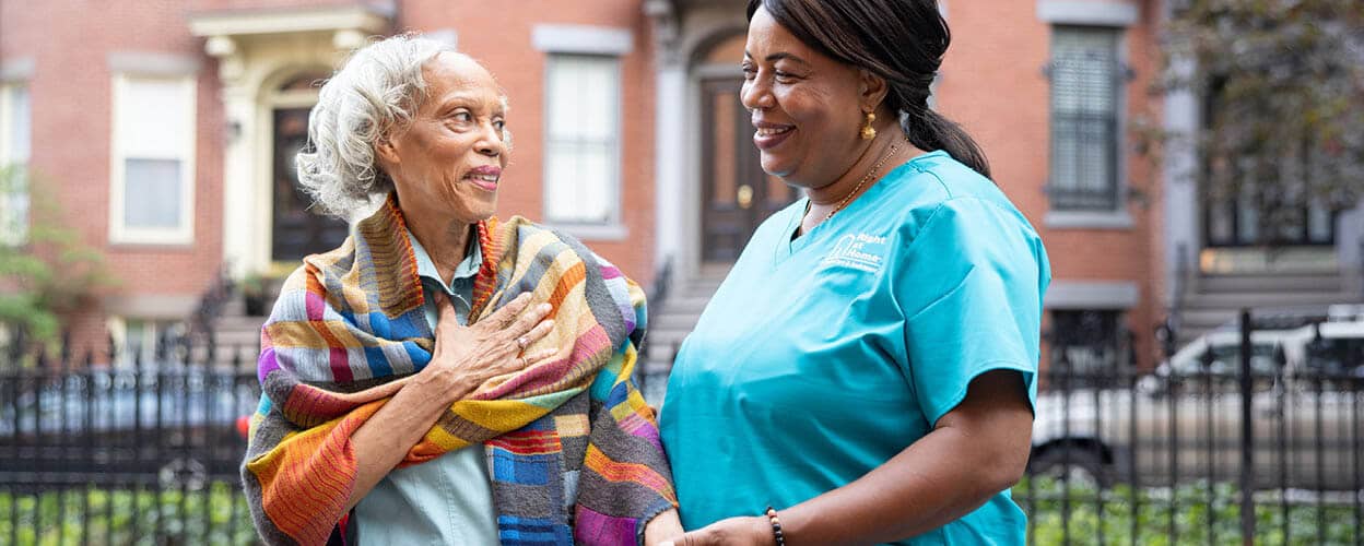 Caregiver and client walking down the sidewalk.