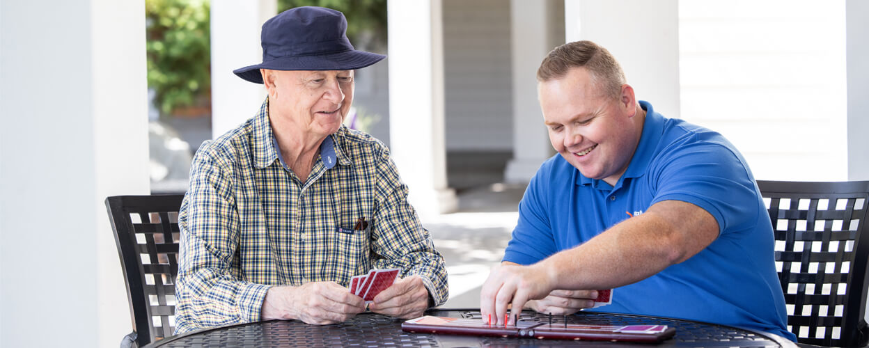 Caregiver and client playing cribbage.