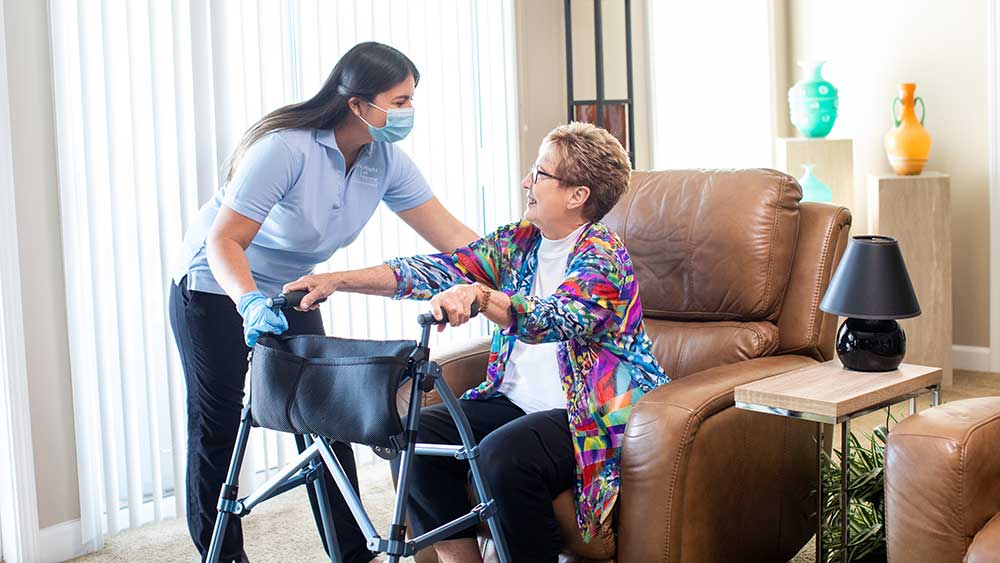 Caregiver assisting senior with limited mobility